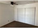 Cozy bedroom features a ceiling fan, carpet, and a closet with sliding doors at 1830 N Pecos Rd # 252, Las Vegas, NV 89115