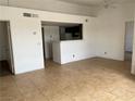 Open living room featuring tile floors, bright white walls, and a pass-through to the kitchen at 1830 N Pecos Rd # 252, Las Vegas, NV 89115