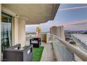 Relax on this balcony with city views, featuring stylish seating and artificial turf for a touch of greenery at 2877 Paradise Rd # 1605, Las Vegas, NV 89109