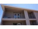 Second-story balcony with railing and glass paneled door; building has stucco exterior and overhang at 2898 Violet Ln # 0, Henderson, NV 89074