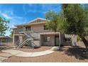 Apartment building featuring pedestrian access and landscaping on a sunny day at 2898 Violet Ln # 0, Henderson, NV 89074