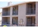Three-story exterior of apartment complex showcasing balconies, doors, and railings at 2898 Violet Ln # 0, Henderson, NV 89074