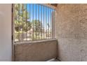 Small balcony with metal railing and a view of desert landscaping and neighborhood at 2964 Juniper Hills Blvd # 104, Las Vegas, NV 89142