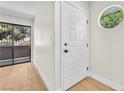 Bright entryway featuring a front door with sidelight and light wood floors at 2964 Juniper Hills Blvd # 104, Las Vegas, NV 89142