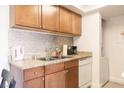 Functional kitchen features granite countertops, stainless steel appliances, and a mosaic backsplash at 4200 S Valley View Blvd # 3053, Las Vegas, NV 89103