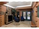 Cozy patio with stone fireplace and seating, featuring a unique ceiling design and desert landscape views at 522 Via Ventana Dr, Mesquite, NV 89027