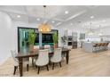 Dining area with modern light fixture and view of the pool at 5225 Villa Dante Ave, Las Vegas, NV 89141