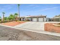 Single-story home boasts three-car garage, desert landscaping, and gated side yard at 544 N Fogg St, Las Vegas, NV 89110