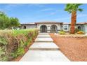 Inviting front entrance with desert landscaping and a walkway to the front door at 544 N Fogg St, Las Vegas, NV 89110