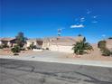 Inviting single-story home with a three-car garage surrounded by lush desert landscaping at 7076 Oakleigh Dr, Las Vegas, NV 89110