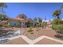 Attractive clubhouse featuring well-manicured landscaping and inviting entrance at 713 Wheat Ridge Ln # 102, Las Vegas, NV 89145