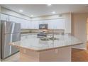 Bright kitchen showcasing granite countertops, stainless steel appliances, and white cabinetry at 713 Wheat Ridge Ln # 102, Las Vegas, NV 89145