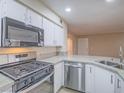 Well-equipped kitchen featuring stainless steel appliances, granite countertops, and ample cabinet space at 713 Wheat Ridge Ln # 102, Las Vegas, NV 89145