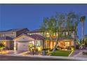 Two-story home with brick driveway, lush landscaping and exterior lighting for curb appeal at 7908 Horse Bridle St, Las Vegas, NV 89131
