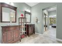 Elegant bathroom features dual vanities with dark wood cabinets and a stone tiled floor at 9900 Summer Ash Ct # 101, Las Vegas, NV 89134