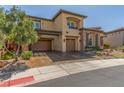 Two-story home with a three-car garage and xeriscaped front yard at 9992 Peak Lookout St, Las Vegas, NV 89178