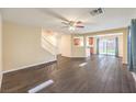 Inviting living room with hardwood floors, a staircase, and an open layout at 10072 Pelham Park Ave, Las Vegas, NV 89148