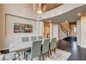 Elegant dining room with a soaring ceiling, large windows and seating for six at 10671 Capesthorne Way, Las Vegas, NV 89135