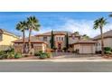 Charming home with mature landscaping, a circular drive, three-car garage and stone accents at 10671 Capesthorne Way, Las Vegas, NV 89135