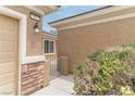 Close-up of the front entrance showcasing stone accents and desert landscaping at 2056 Bay Thrush Way, North Las Vegas, NV 89084