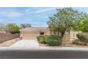 Charming single-story home featuring desert landscaping and a well-manicured yard at 2056 Bay Thrush Way, North Las Vegas, NV 89084