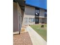 Exterior apartment buildings with gated doors, and a front lawn area at 236 N Bruce St # C, Las Vegas, NV 89101