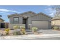 Charming single-story home features a well-manicured front yard and a two-car garage at 2395 Arrington Ave, North Las Vegas, NV 89086