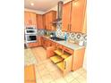 This kitchen has granite counters, designer backsplash and pull out drawer shelves at 2395 Arrington Ave, North Las Vegas, NV 89086
