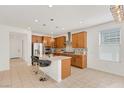 Bright eat-in kitchen featuring an island, stainless steel appliances, and decorative backsplash at 2395 Arrington Ave, North Las Vegas, NV 89086