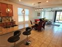 Open-concept living space featuring a kitchen island and a view of the living room at 2395 Arrington Ave, North Las Vegas, NV 89086