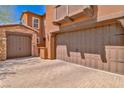 A two-car and one-car garage with brick driveway at 2497 Birch Hollow St, Henderson, NV 89044