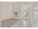 Grand foyer boasts soaring ceilings, decorative chandelier, and tile flooring at 2753 Kildrummie St, Henderson, NV 89044