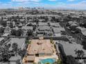 Expansive aerial shot showcasing the backyard pool and lush landscaping, set against a cityscape backdrop at 277 Dark Forest Ave, Las Vegas, NV 89123