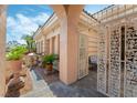 Inviting entrance with an iron gate, decorative plants, and a charming seating area, adding character at 277 Dark Forest Ave, Las Vegas, NV 89123