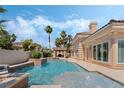 Refreshing backyard pool with waterfall features and a cozy cabana, perfect for outdoor relaxation at 277 Dark Forest Ave, Las Vegas, NV 89123