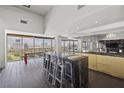 Modern kitchen featuring black marble countertops, light cabinetry, and floor-to-ceiling windows with city views at 3111 Bel Air Dr # 27E, Las Vegas, NV 89109