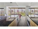 Spacious kitchen with stainless steel appliances, marble countertops, light cabinetry, and cityscape views at 3111 Bel Air Dr # 27E, Las Vegas, NV 89109