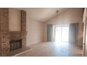 Spacious living room features a brick fireplace, vaulted ceilings, and new floors at 3232 Dayflower St # 4, Las Vegas, NV 89121