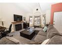 Comfortable living room features a fireplace, large windows, and a plush sectional sofa at 3236 Manzanita Ln, Laughlin, NV 89029