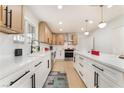 Bright kitchen features white cabinets, long countertops with modern appliances, and stylish black hardware at 4237 E Twain Ave, Las Vegas, NV 89121