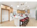 Bright kitchen features white cabinets, large island with seating, modern appliances, and stylish pendant lighting at 4237 E Twain Ave, Las Vegas, NV 89121