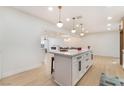 Bright kitchen features a large island with seating and modern pendant lighting overlooking open floorplan at 4237 E Twain Ave, Las Vegas, NV 89121