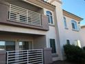 Exterior view of a two-story apartment showcasing balconies and multiple windows at 4555 E Sahara Ave # 226, Las Vegas, NV 89104