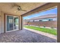 Covered patio with brick flooring and a ceiling fan, providing a cozy outdoor space at 508 Cadence View Way, Henderson, NV 89011