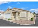 Well-maintained single-story home with a two-car garage, desert landscaping, and private driveway at 5109 Midnight Oil Dr, Las Vegas, NV 89122