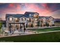 Beautiful multi-story home featuring well-manicured lawns, desert landscaping, and scenic sunset views at 620 Bellus Pl # Lot 168, Henderson, NV 89015