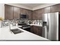 Modern kitchen featuring stainless steel appliances, mosaic backsplash, and white countertops at 620 Bellus Pl # Lot 168, Henderson, NV 89015