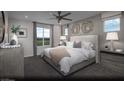 Serene primary bedroom with a comfortable bed, neutral tones, and ample natural light from the large window at 620 Bellus Pl # Lot 168, Henderson, NV 89015
