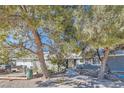 Single-story home with a gray exterior and landscaping, offering comfortable living at 6325 Guy Ave Ave, Las Vegas, NV 89131