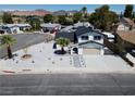 Aerial view of a charming home with a well-manicured yard and an attached two-car garage at 652 Del Prado Dr, Boulder City, NV 89005